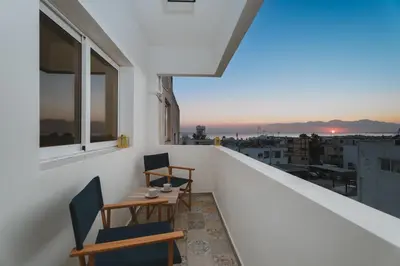 a balcony with two chairs and a table at Modern seaview apartment in the heart of Agia Napa in Ayia Napa