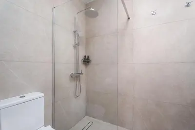 a bathroom with a shower with a glass door at Modern seaview apartment in the heart of Agia Napa in Ayia Napa