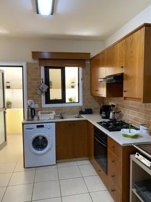 a kitchen with a washing machine and a window at Kition Cozy Residence in Larnaka