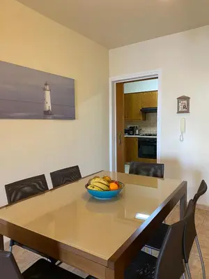 a dining room table with a bowl of fruit on it at Kition Cozy Residence in Larnaka