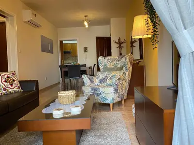 a living room with a couch and a chair at Kition Cozy Residence in Larnaka