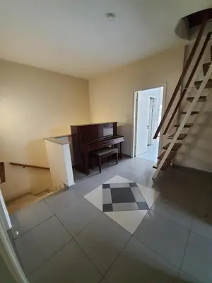 an empty room with a piano and a staircase at Bright and Cozy 2-Bedroom Apartment in Strovolos in Strovolos