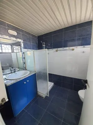 a bathroom with a sink and a mirror and a toilet at Bright and Cozy 2-Bedroom Apartment in Strovolos in Strovolos