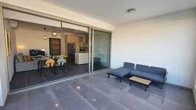 a living room with a couch and a table at STAY Larnaca Pearl Apartment in Larnaka