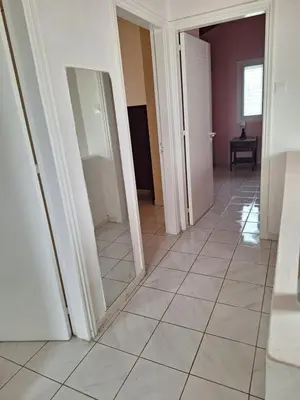 a hallway with two mirrors and a tiled floor at Big house near sea, shared swimming pool in Voroklini