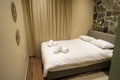 two stuffed animals sitting on a bed in a room at Luxury 5-Bedroom Chalet Kalopanayiotis in Kalopanayiotis
