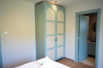 a bedroom with a blue door and a closet at Luxury 5-Bedroom Chalet Kalopanayiotis in Kalopanayiotis