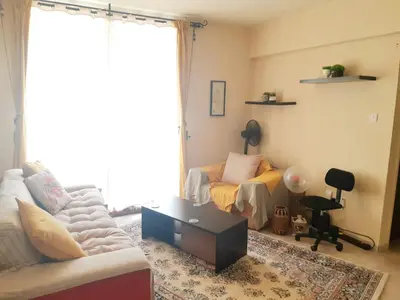 a living room with a couch and a coffee table at Cozy apartment in Larnaka