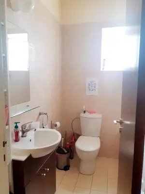 a bathroom with a toilet and a sink at Cozy apartment in Larnaka