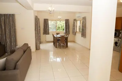a living room with a couch and a table at Anthorina Villa 21 in Protaras