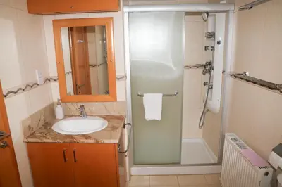 a bathroom with a sink and a shower at Anthorina Villa 21 in Protaras