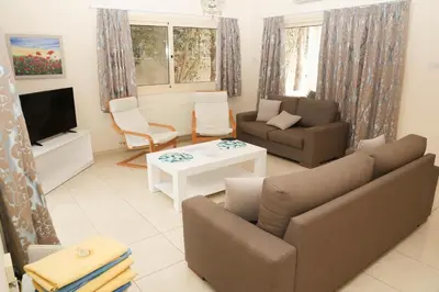 a living room with a couch and a tv at Anthorina Villa 21 in Protaras