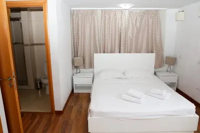 a bedroom with a white bed with two towels on it at Anthorina Villa 21 in Protaras