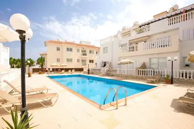a swimming pool in the middle of a building at Jules Apartment in Paralimni
