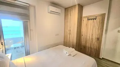 a bedroom with a bed with two white towels on it at Touch of class Molos Limassol in Limassol