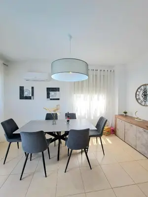 a dining room with a table and chairs at SERENITY PEARL VILLA at the sea in Protaras