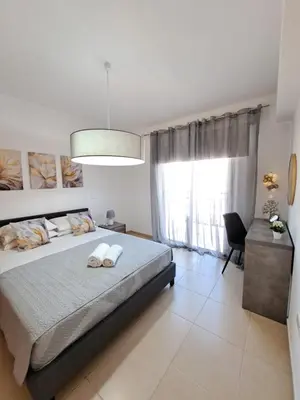 a bedroom with a large bed and a large window at SERENITY PEARL VILLA at the sea in Protaras