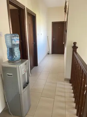 a hallway with a water machine with a stack of water bottles at Tranquil paradise in Aradhippou
