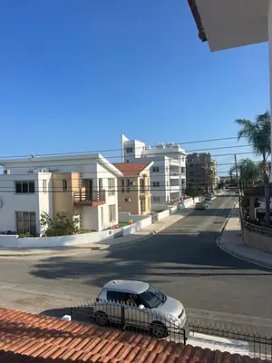a silver car parked on a street with buildings at Tranquil paradise in Aradhippou