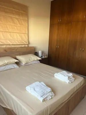 a bedroom with a bed with two towels on it at Tranquil paradise in Aradhippou