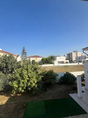 a view from the balcony of a house with a green yard at Tranquil paradise in Larnaka
