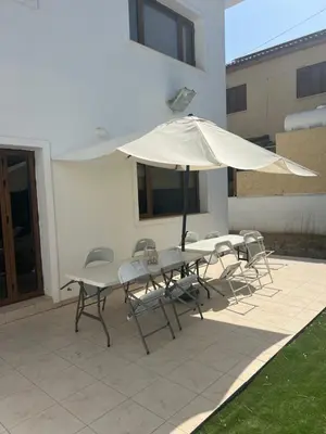 a table and chairs with an umbrella on a patio at Tranquil paradise in Larnaka