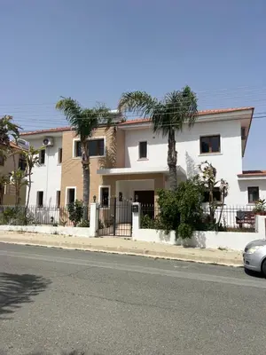a house on the side of a street with palm trees at Tranquil paradise in Larnaka