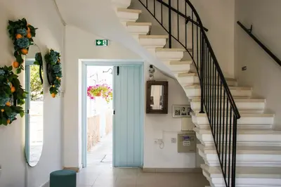 a staircase in a house with a blue door at Siogkas Inn in Dherinia