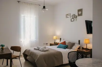 a bedroom with a bed and a table and chairs at Siogkas Inn in Dherinia