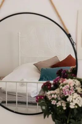 a bedroom with a bed with a mirror and flowers at Siogkas Inn in Dherinia