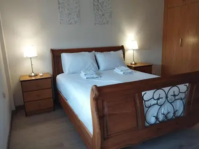 a bedroom with a bed with two lamps on it at Kafkalia Sea Breeze in Larnaka
