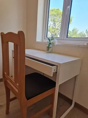 a desk with a chair and a window at Kafkalia Sea Breeze in Larnaka