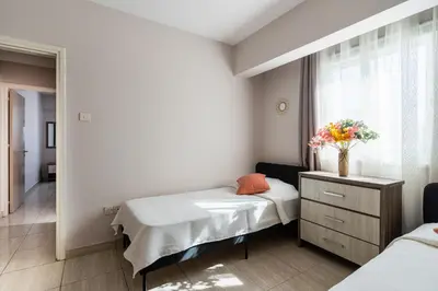 a hospital room with two beds and a window at Carisa flat, 2 bedrooms in Larnaka