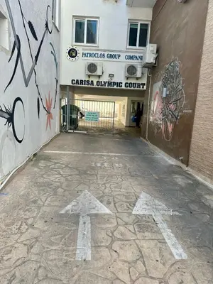 an arrow on the ground in front of a building with graffiti at Carisa flat, 2 bedrooms in Larnaka