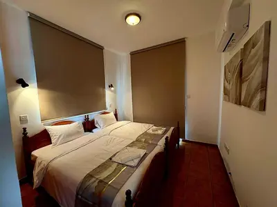 a bedroom with a large bed with a large window at Villa Solmare in Pervolia