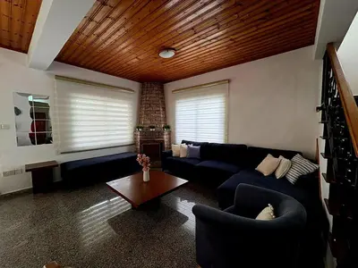 a living room with a couch and a table at Villa Solmare in Pervolia