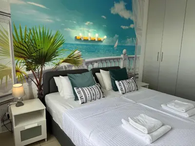a bedroom with a bed with a view of the ocean at Protaras Sunset Bay in Protaras
