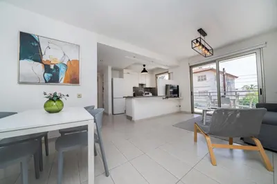 a kitchen and living room with a table and chairs at Central Luxurious 2 bedroom flat in Strovolos