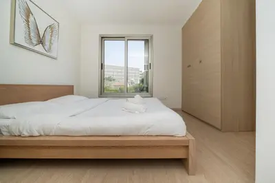 a bedroom with a large bed and a large window at Central Luxurious 2 bedroom flat in Strovolos