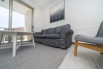 a living room with a couch and a table at Central Luxurious 2 bedroom flat in Strovolos