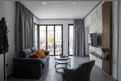 a living room with a couch and a table at Le Bouquet Luxury Suites Ltd in Nicosia