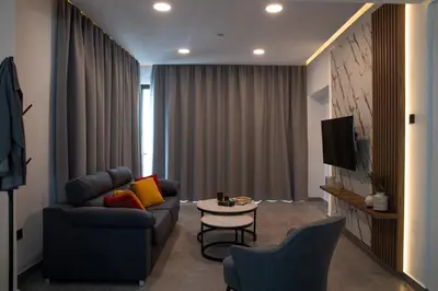 a living room with a couch and a table at Le Bouquet Luxury Suites Ltd in Nicosia