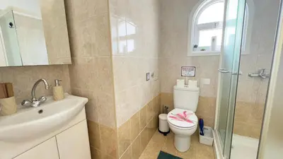 a bathroom with a toilet and a sink and a shower at Hills 2bdr Seaside Makenzy Larnaka in Larnaka