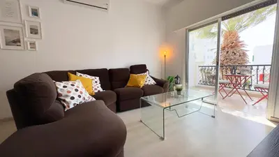 a living room with a couch and a glass table at Hills 2bdr Seaside Makenzy Larnaka in Larnaka