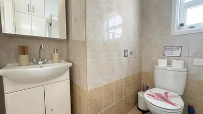 a bathroom with a sink and a toilet at Hills 2bdr Seaside Makenzy Larnaka in Larnaka