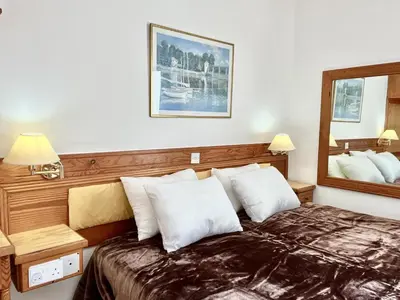 a hotel room with a bed and a mirror at STAY NISSI Chrysland Studios in Ayia Napa