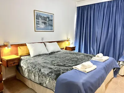 a bedroom with two beds with towels on them at STAY NISSI Chrysland Studios in Ayia Napa