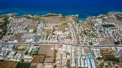 an aerial view of a parking lot in front of the ocean at Mythical Sands Apartment BA09 in Protaras