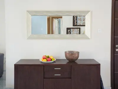 a bowl of fruit on a dresser under a mirror at Mediterranean Escape - Coastal 2-Bedroom Apartment Limassol in Limassol
