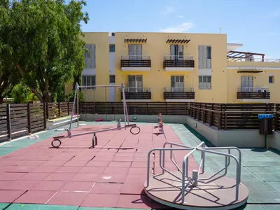 an empty playground in front of a building at Mediterranean Escape - Coastal 2-Bedroom Apartment Limassol in Limassol